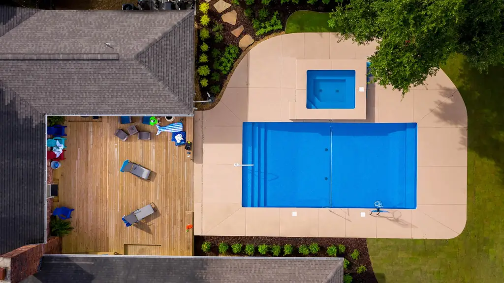 Pool and spa side by side next to a wood deck